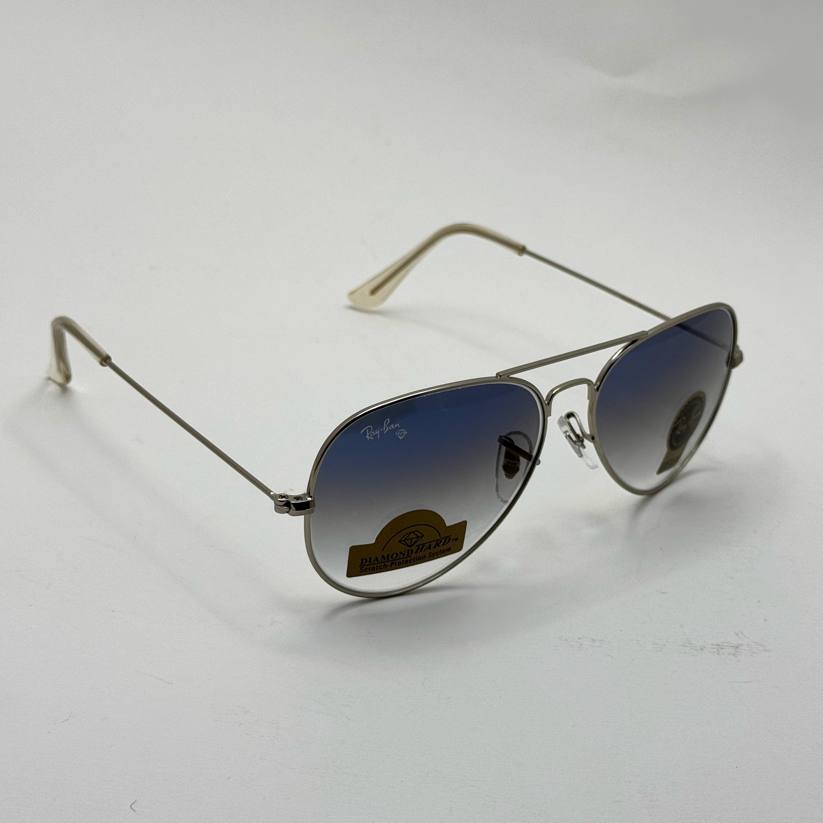 عینک ریبن خلبانی شیشه سنگ آبی هایلایت فریم نقره ای به همراه پک کامل ریبن Rayban RB 3025 (ارسال رایگان)